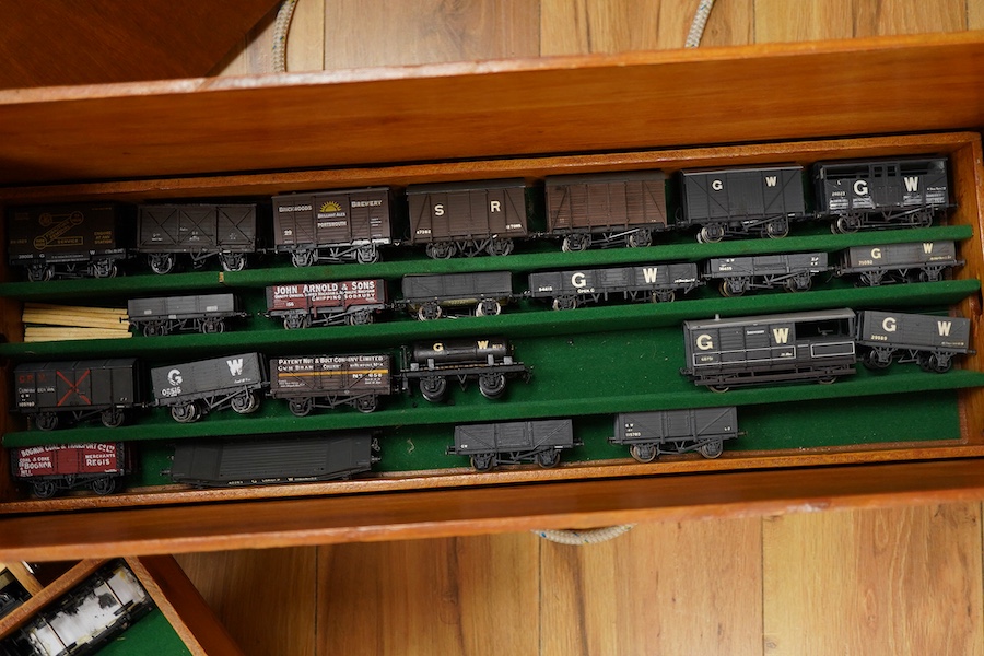 130 items of EM gauge model railway rolling stock contained within three handmade fitted wooden cases, two with removable trays, comprising three locomotives; an SR class 700 0-6-0 tender locomotive, 693, an SR 0-4-0T, 7